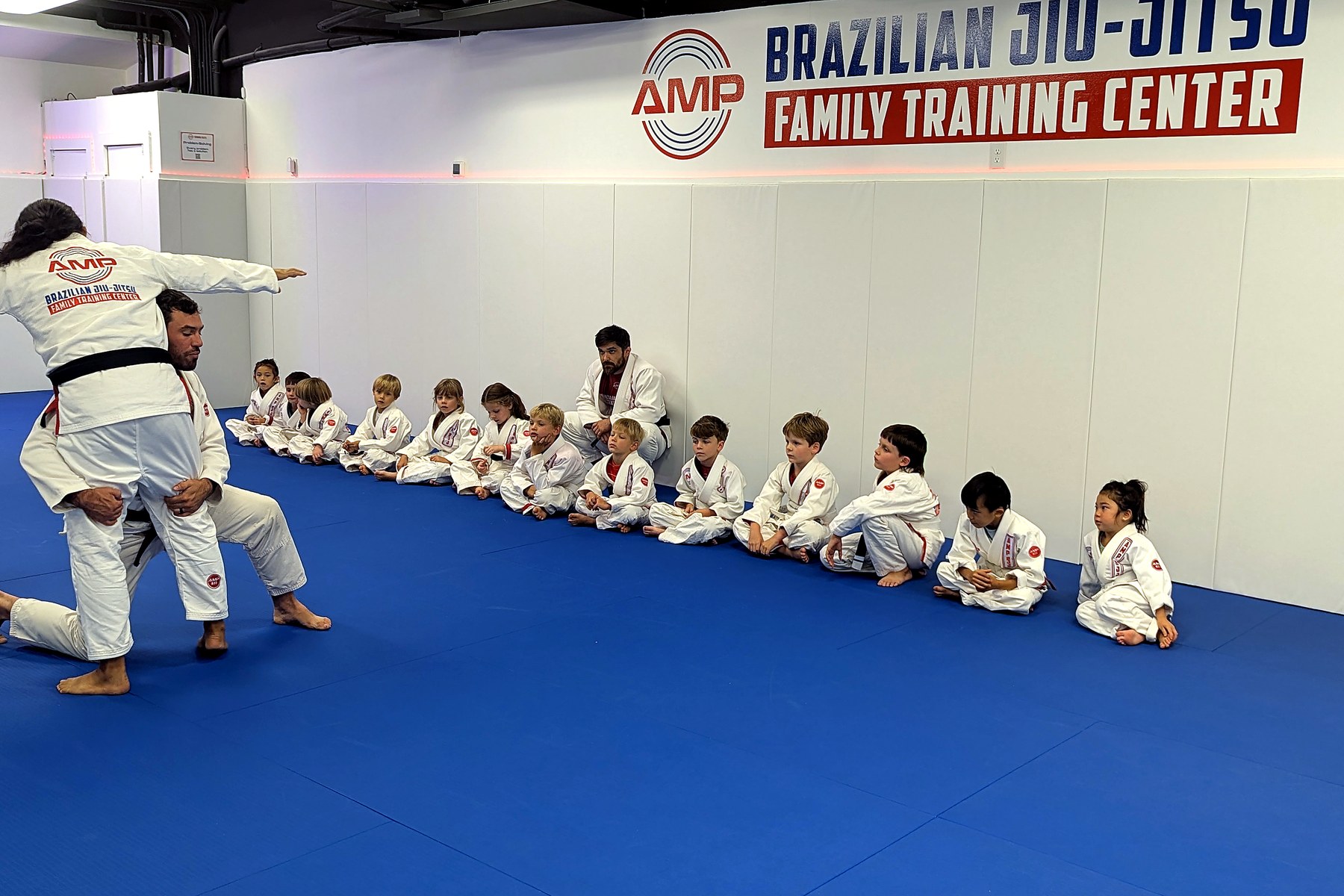 AMP BJJ instructor teaching kids during an after-school Brazilian Jiu-Jitsu class in Austin