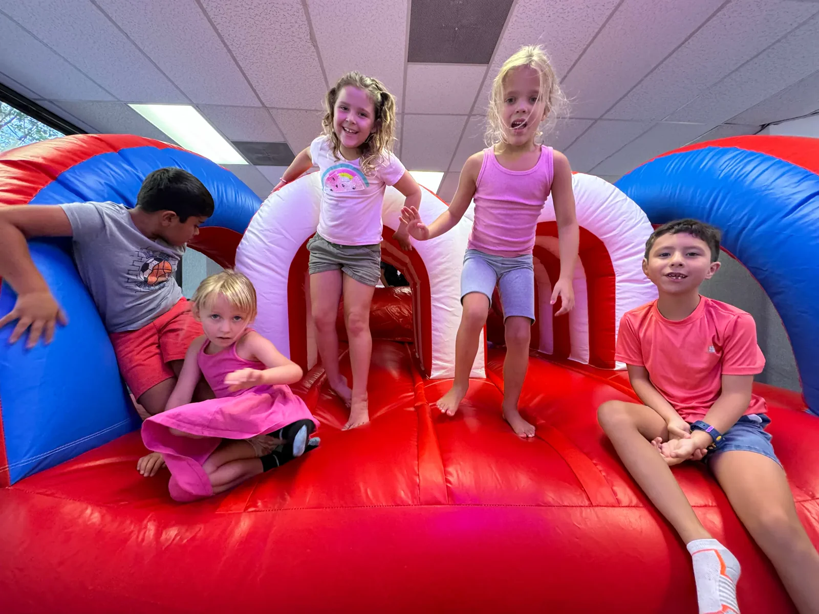 AMP BJJ day camp kids playing on an indoor inflatable during games time in Austin, TX