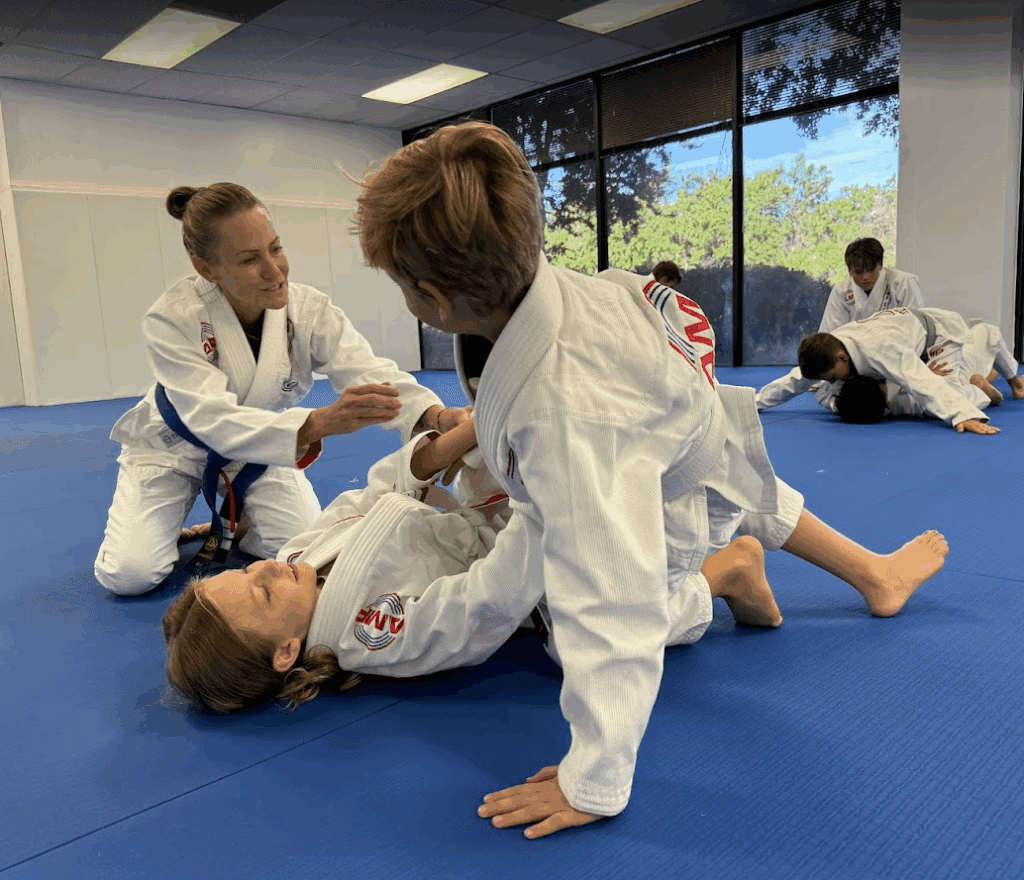 Kids learning Brazilian Jiu-Jitsu at AMP BJJ with hands-on instruction